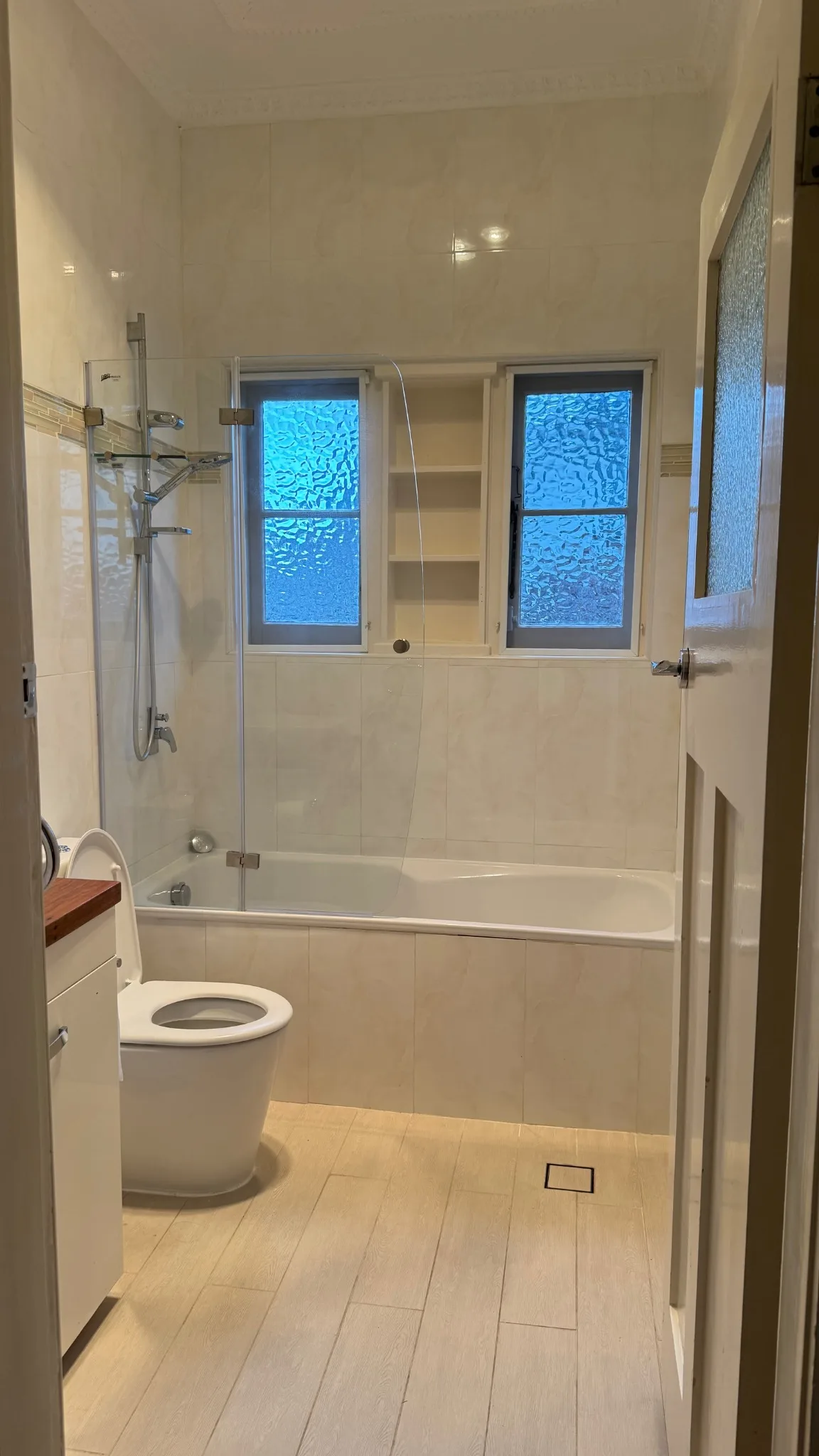 Main bathroom before renovation, showing the existing bathtub and fittings