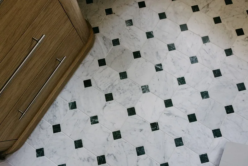 Patterned bathroom floor tiles with green diamond details