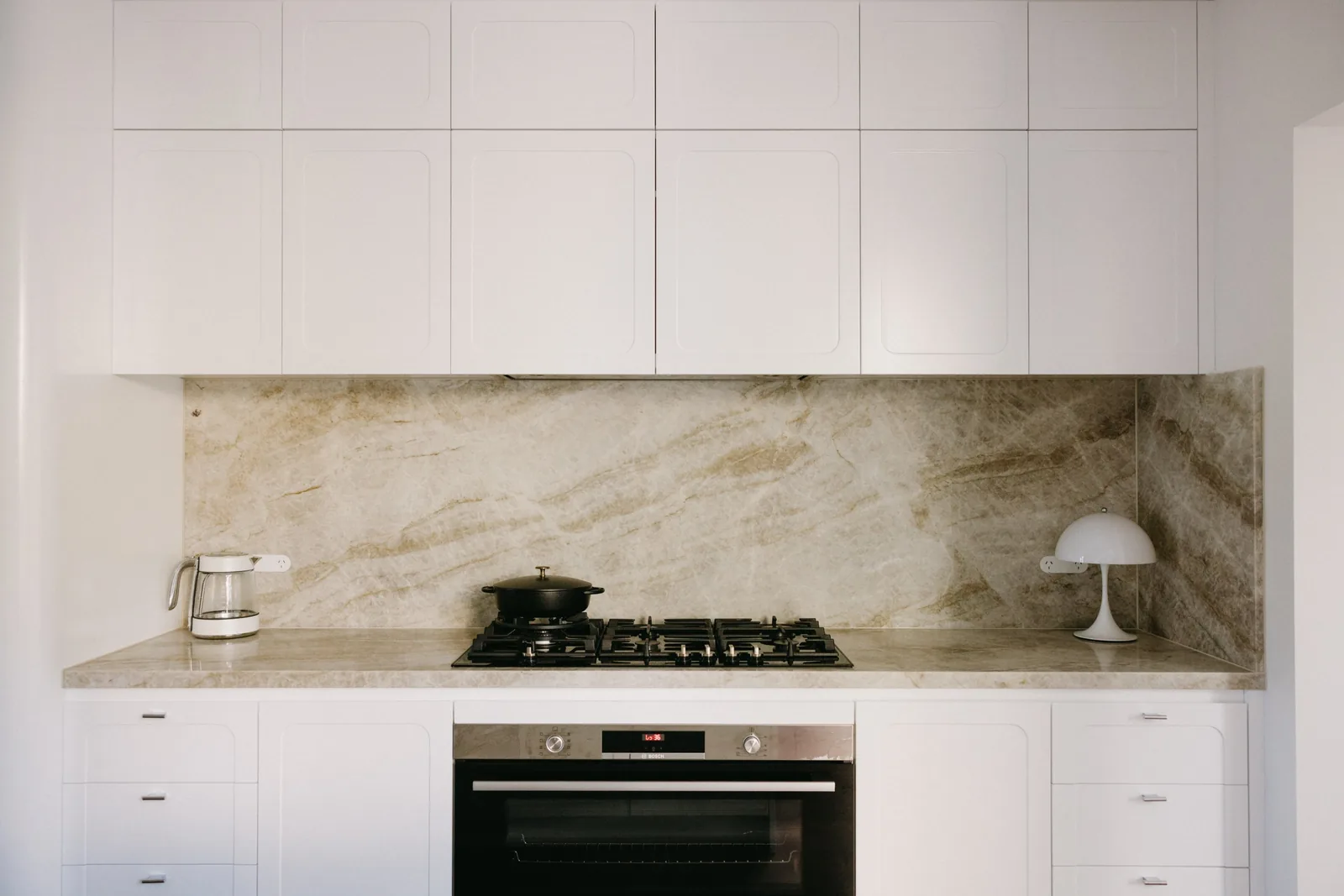 Completed Paddington kitchen with stone splashback and cooktop