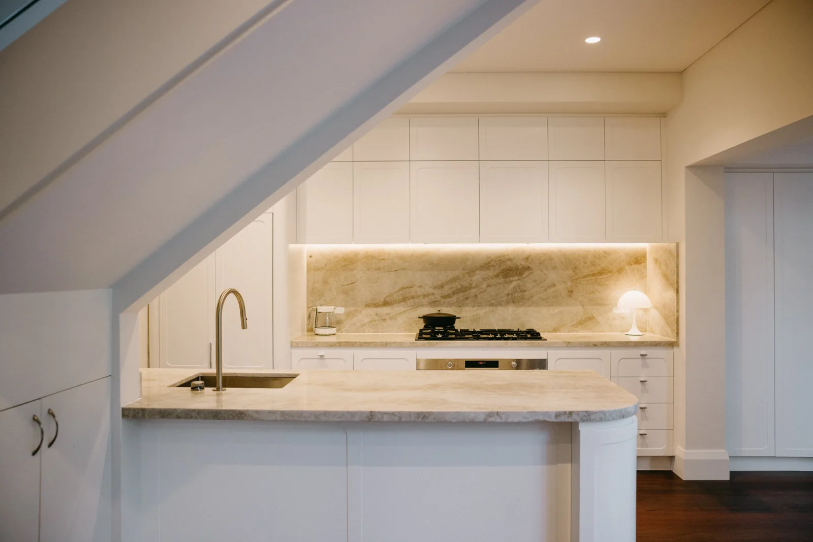 Peninsula and stone splashback after renovation